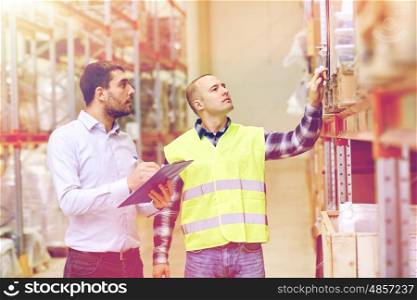 wholesale, logistic, people and export concept - manual worker and businessmen with clipboards at warehouse