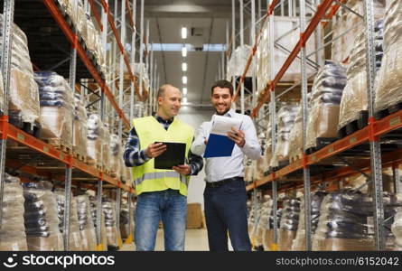 wholesale, logistic, people and export concept - manual worker and businessmen with clipboards at warehouse