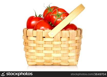 Wicker basket full of tomatoes, isolated on white background