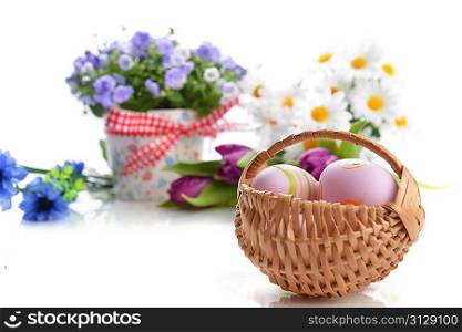 wicker basket of easter eggs with flowers