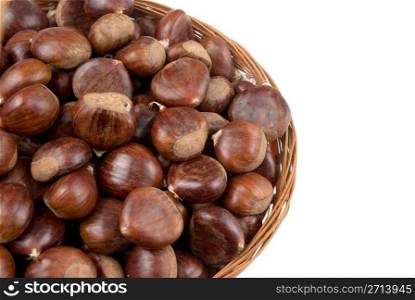 Wicker basket with chestnuts isolated on white background.