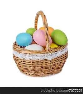 Wicker basket with multicolored Easter eggs isolated on white background