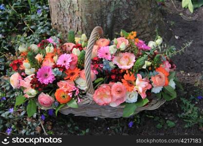 Wicker bsket with mixed flowers in bright colors