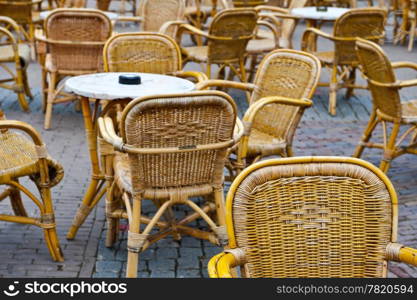 Wicker Chairs and Tables in a Street Cafe