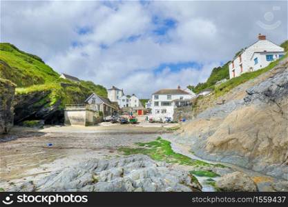 wide angle scenic view of the traditional Cornish village Portloe, with the Fishing boats on the beach on the south Cornwall coast. UK