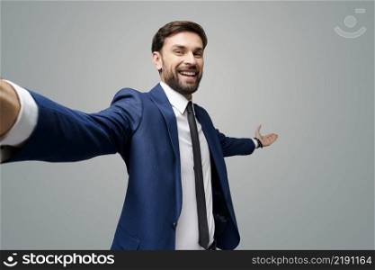 wide angle selfie studio shot of a young businessman pointing on a copyspace with his hand. wide angle selfie shot of a young businessman pointing on a copyspace with his hand