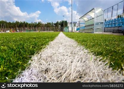 Wide angle shot from marking line of soccer field at sunny day