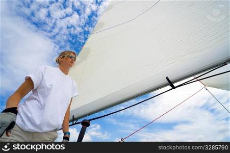 Wide angle shot of beautiful young woman standing on the deck of a boat