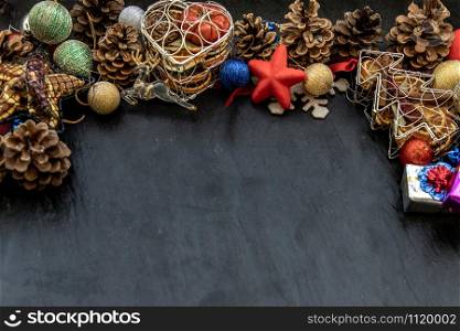 Wide arch shaped Christmas decoration border. Twigs christmas tree, brown natural pine cones and and Xmas deer with variety of fruits on dark background, Copy space.
