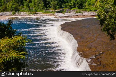 Wide flat waterfall at Ranney Falls on Trent River near Campbellford, Ontario, Canada.