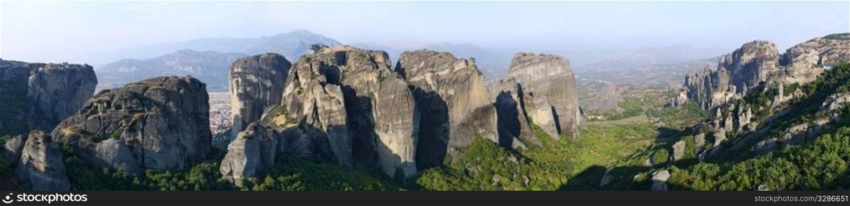 Wide panorama of the miracle Meteora rock monasteries for hermits. Greece.