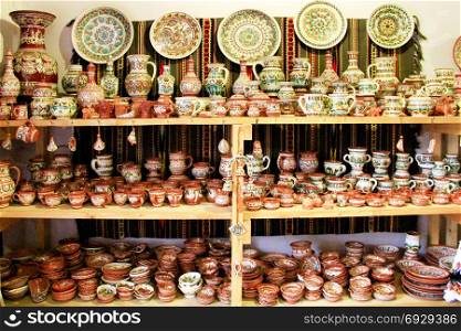 wide range of ceramic products. earthenware on the shelves of pottery shop. Art of pottery