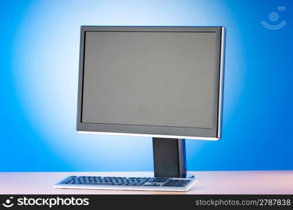 Wide screen computer monitor against colorful background