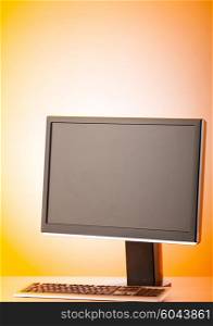 Wide screen computer monitor against colorful background