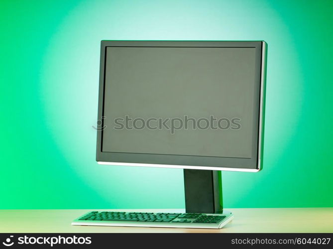 Wide screen computer monitor against colorful background