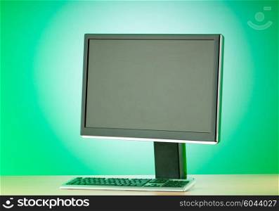 Wide screen computer monitor against colorful background