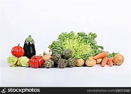 Wide studio shot of a variety of fresh vegetables