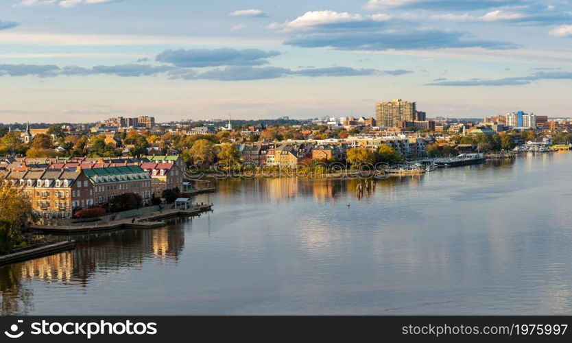 Wide view of the historic city of Alexandria and the waterfront property along the Potomac River in northern Virginia. Waterfront of city of Alexandria in Virginia at sunset