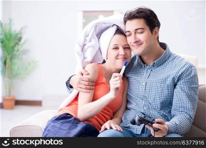 Wife and husband looking at pregnancy test