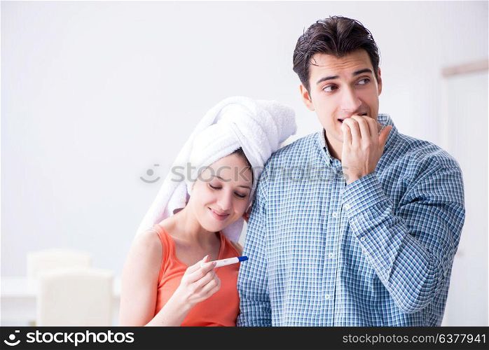 Wife and husband looking at pregnancy test