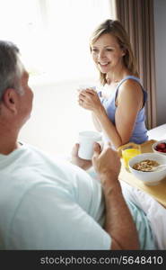 Wife Bringing Husband Breakfast In Bed On Tray