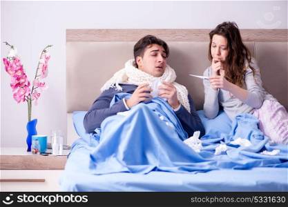 Wife caring for sick husband at home in bed