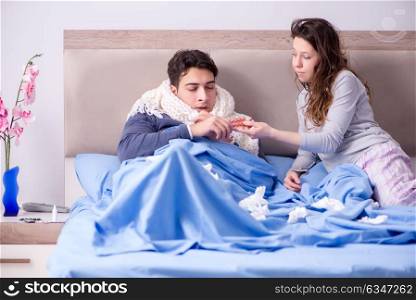 Wife caring for sick husband at home in bed