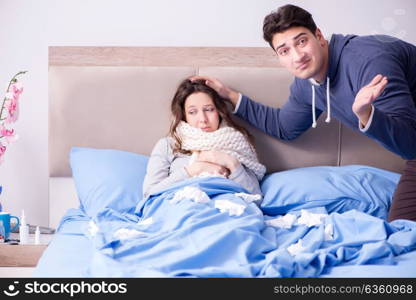 Wife caring for sick husband at home in bed