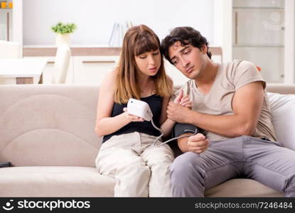 Wife checking husband&rsquo;s blood pressure  . Wife checking husband&rsquo;s blood pressure 
