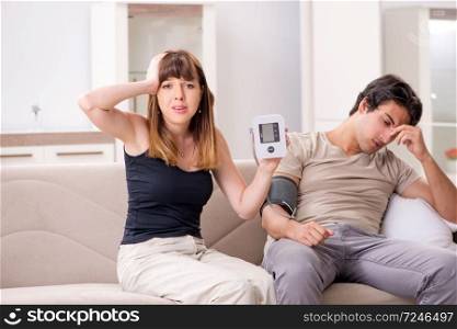 Wife checking husband’s blood pressure  . Wife checking husband’s blood pressure 