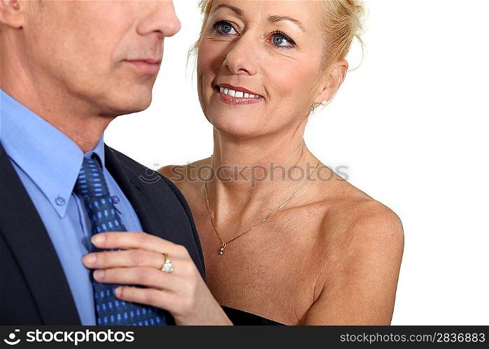Wife helping husband with tie