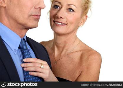 Wife helping husband with tie