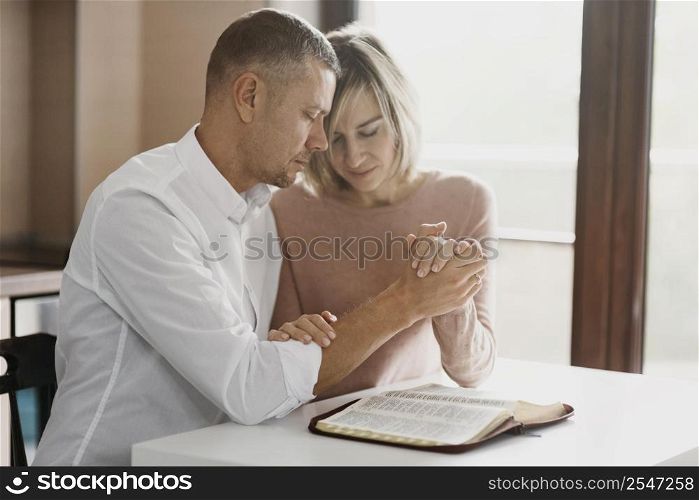wife husband praying together home