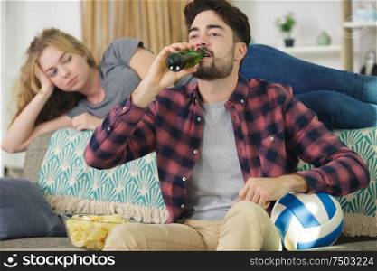 wife is upset because her husband is watching football