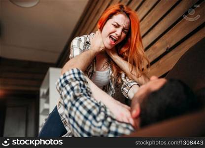 Wife try to strangles her husband, quarrel, family conflict, domestic violence. Problem relationship. Wife strangles her husband, quarrel, conflict