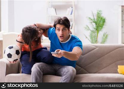 Wife unhappy that husband is watching football