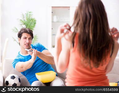 Wife unhappy that husband is watching football