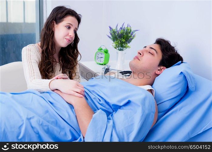 Wife visiting ill husband in the hospital room