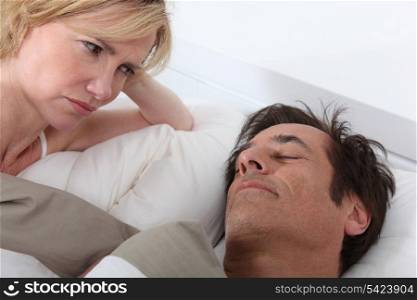 Wife watching husband sleeping