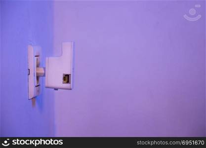 WiFi repeater in electrical socket on the wall. Device that help to extend wireless network in home or office.