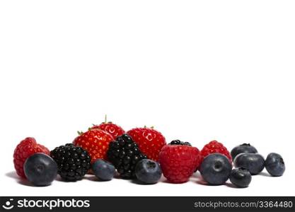 wild berries on white. blueberries, strawberries blackberries and raspberries on white background