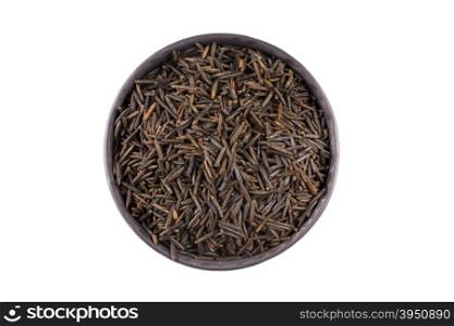 Wild brown rice in bowl and loose over white background