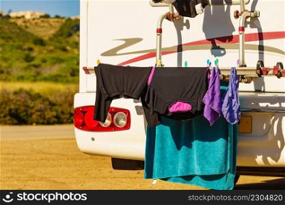 Wild c&ing on nature. Caravan vehicle with clothes hanging to dry. Holidays with motor home.. Caravan with clothes to dry