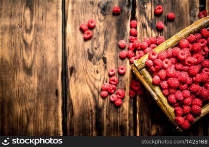 Wild raspberries in the basket. On a wooden table.. Wild raspberries in the basket.
