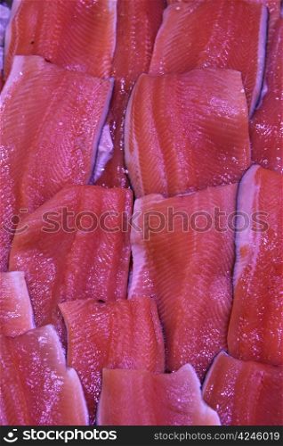Wild salmon filets on ice in a fish shop
