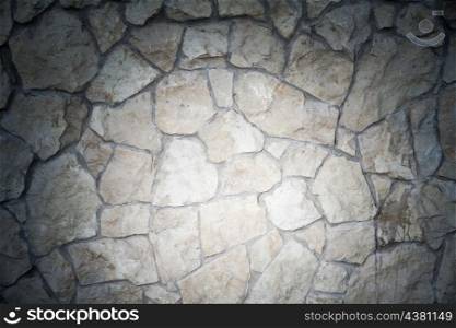 wild stone wall with spot of light