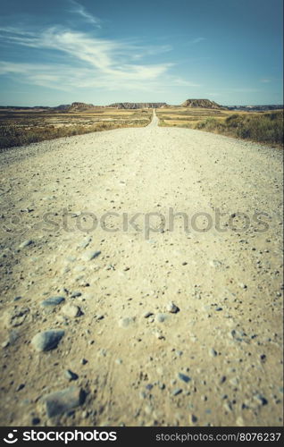 Wild west dirt road and stone mountains