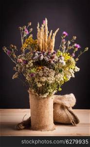 Wildflowers in the bagging vase on a table