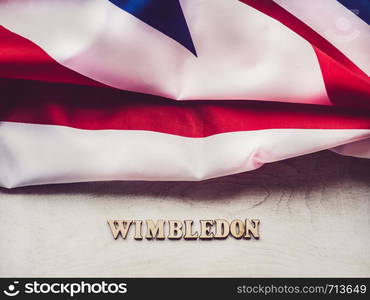 WIMBLEDON. Wooden, unpainted letters on a white table. Close-up, top view. Beautiful photo for invitation card. WIMBLEDON. Beautiful, bright photo for invitation card