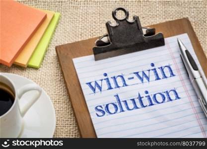 win-win solution concept - handwriting on a clipboard with a cup of coffee
